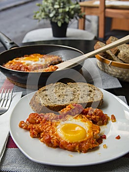 Shakshouka - dish of eggs fried with tomatoes onions and fried egg