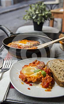 Shakshouka - dish of eggs fried with tomatoes onions and fried egg