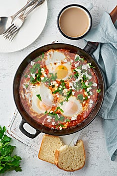 Shakshouka, eggs poached in sauce of tomatoes, olive oil. Mediterranean cousine