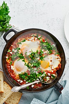 Shakshouka, eggs poached in sauce of tomatoes, olive oil. Mediterranean cousine