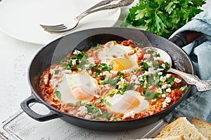 Shakshouka, eggs poached in sauce of tomatoes, olive oil. Mediterranean cousine