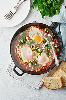 Shakshouka, eggs poached in sauce of tomatoes, olive oil. Mediterranean cuisine.