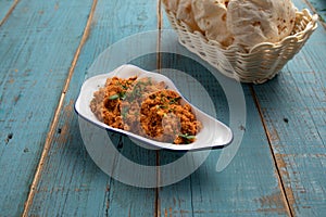 shakshouka with pta bread served in a dish side view isolared on wooden table photo