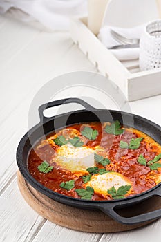 Shakshuka - a dish of eggs fried in a sauce of tomato