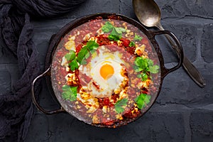 Shakshuka -  dish of eggs poached in a tomato sauce with Feta cheese and coriander