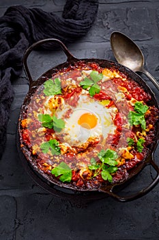 Shakshuka -  dish of eggs poached in a tomato sauce with Feta cheese and coriander