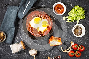 Shakshuka, Fried Eggs in Tomato Sauce in iron frying pan. Typical Israel food