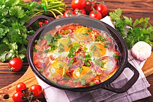 Shakshuka. Traditional Israeli cuisine. Fried eggs with vegetables