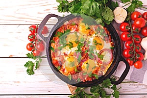 Shakshuka. Traditional Israeli cuisine. Fried eggs with vegetables