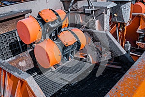 Shale shaker on an offshore oil rig. Shale shaker screen close up view with drill cutting flow out from oil base mud. Separators