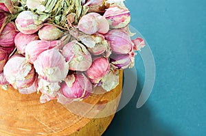 Shallot onions in a group on wood chopping block