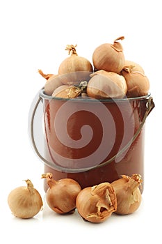 Shallots in a brown enamel cooking pot