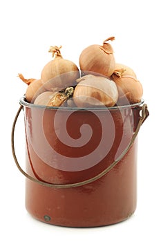 Shallots in a brown enamel cooking pot