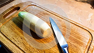 Shallots on a cutting board with a knife