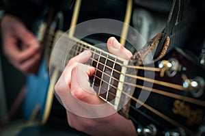 shallow depth of field fingers playing guitar strings