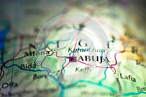 Shallow depth of field focus on geographical map location of Abuja city in Nigeria Africa continent on atlas