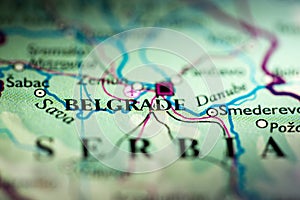 Shallow depth of field focus on geographical map location of Belgrade city Serbia Europe continent on atlas