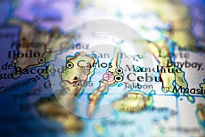 Shallow depth of field focus on geographical map location of Cebu city in Visayas Philippines Asia continent on atlas