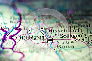 Shallow depth of field focus on geographical map location of Cologne city Germany Europe continent on atlas