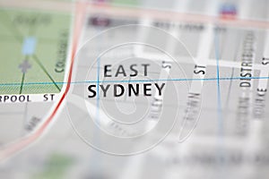 Shallow depth of field focus on geographical map location of East Sydney Sydney Australia Asia continent on atlas