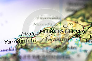 Shallow depth of field focus on geographical map location of Hiroshima city in Honshu Island Japan Asia continent on atlas