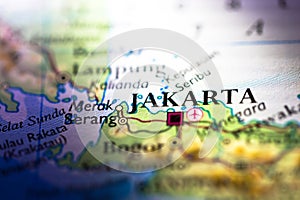Shallow depth of field focus on geographical map location of Jakarta city in Indonesia Asia continent on atlas