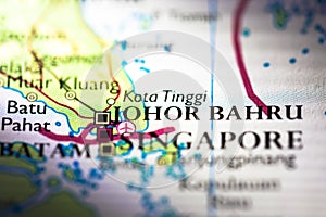 Shallow depth of field focus on geographical map location of Johor Bahru city in Malaysia Asia continent on atlas