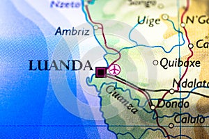 Shallow depth of field focus on geographical map location of Luanda city in Angola Africa continent on atlas