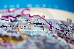 Shallow depth of field focus on geographical map location of Mount Distaghil Sar in Pakistan Asia continent on atlas