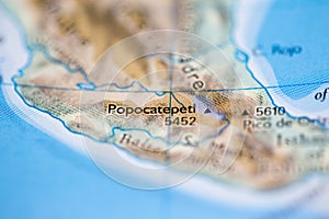 Shallow depth of field focus on geographical map location of Mount Popocatepetl in Mexico South America continent on atlas