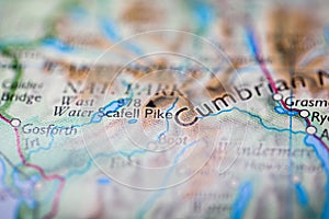 Shallow depth of field focus on geographical map location of Mount Scafell Pike in England Europe continent on atlas