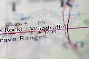 Shallow depth of field focus on geographical map location of Mount Woodroffe in Australia Ocenia continent on atlas photo