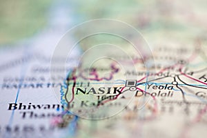 Shallow depth of field focus on geographical map location of Nasik India Asia continent on atlas photo