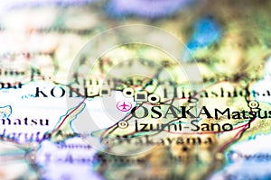 Shallow depth of field focus on geographical map location of Osaka city in Honshu Island Japan Asia continent on atlas
