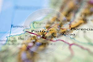 Shallow depth of field focus on geographical map location of Pasto city Colombia South America continent on atlas photo