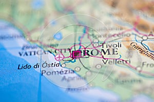 Shallow depth of field focus on geographical map location of Rome city Italy Mediterranean Europe continent on atlas