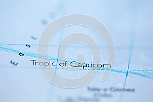 Shallow depth of field focus on geographical map location of Tropic of Capricorn line on atlas