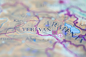 Shallow depth of field focus on geographical map location of Yerevan city Armenia Europe continent on atlas