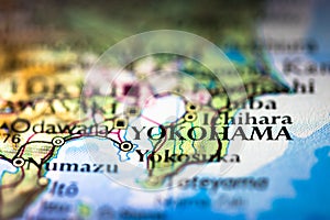 Shallow depth of field focus on geographical map location of Yokohama city in Honshu Island Japan Asia continent on atlas
