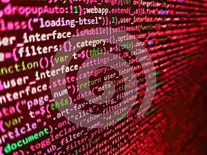 Shallow depth of field, selective focus effect. Lines of code of a software with several colors. Concept of security, programming