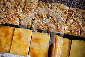 Shallow depth of field selective focus image with details of various types of sweet cakes