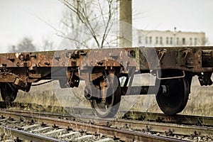Shallow depth of field selective focus image with old and rusty railway industrial transportation waggon dresine
