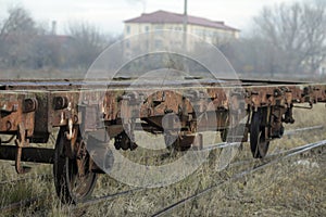 Shallow depth of field selective focus image with old and rusty railway industrial transportation waggon dresine