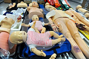 Shallow depth of field selective focus image with plastic dummies babies and adults used for CPR training