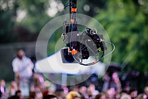 Shallow depth of field selective focus image with a professional video camera on a crane during an outdoor event