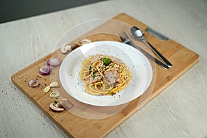 Shallow depth of field spaghetti carbonara on wooden table