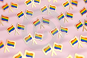 Shallow DOF focus on Rainbow LGBTQ flags pattern. Gay pride month symbol concept.  on pastel pink background. 3D rendering