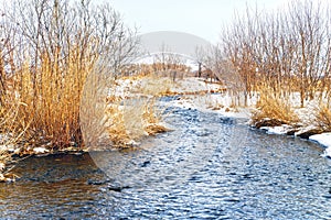 Shallow, fast, unfrozen river in winter. Snow melts spring streams. HDR