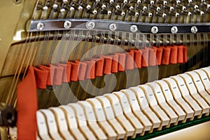 Shallow focus close-up of tools for tuning the internal mechanisms of an upright piano. Gives a feeling of luxury, classic, luxury