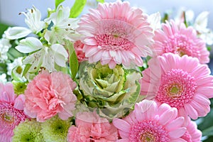 Shallow focus closeup shot of a pink bouquet of Transvaal Daisy, Lily, Rose, Peony flowers